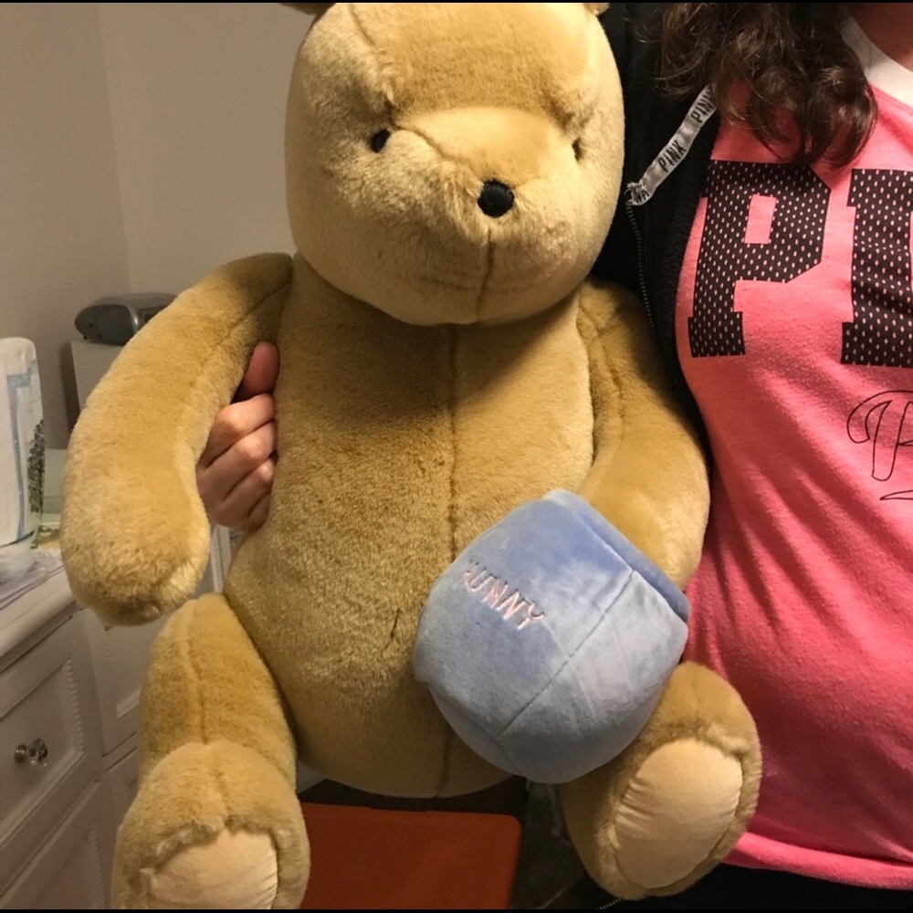 Bedding, stuffed Pooh and trash can cover.